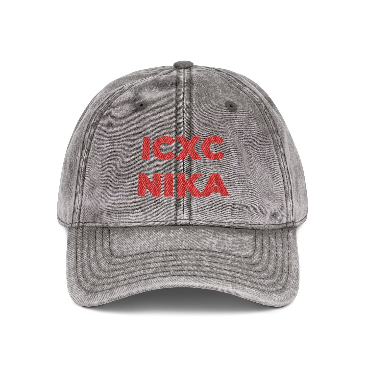 Charcoal grey distressed denim cap embroidered with bold red “ICXC NIKA,” the Orthodox Christian Christogram meaning “Jesus Christ Conquers.”.