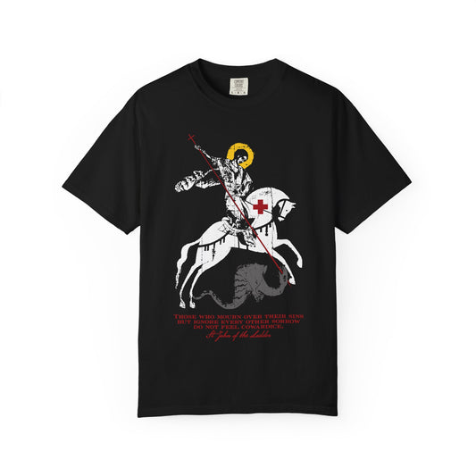Black heavyweight cotton unisex tee featuring an iconographic graphic of St George slaying the dragon, inspired by St John Climacus, with the phrase “Those Who Mourn Over Their Sins” beneath the illustration—an Orthodox Christian design that poignantly expresses themes of spiritual struggle and the sadness of soul.
