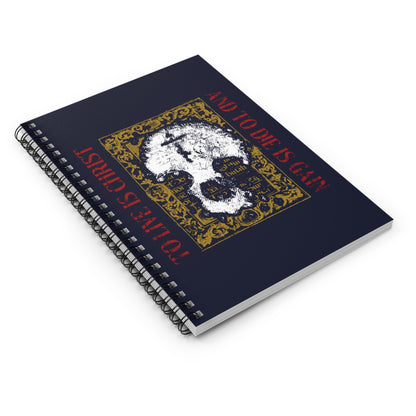Navy spiral notebook: "To Live is Christ, to Die is Gain" (Philippians 1:21) with white skull and cross on gold manuscript texture—a daily Orthodox reminder of living out faith in Christ.