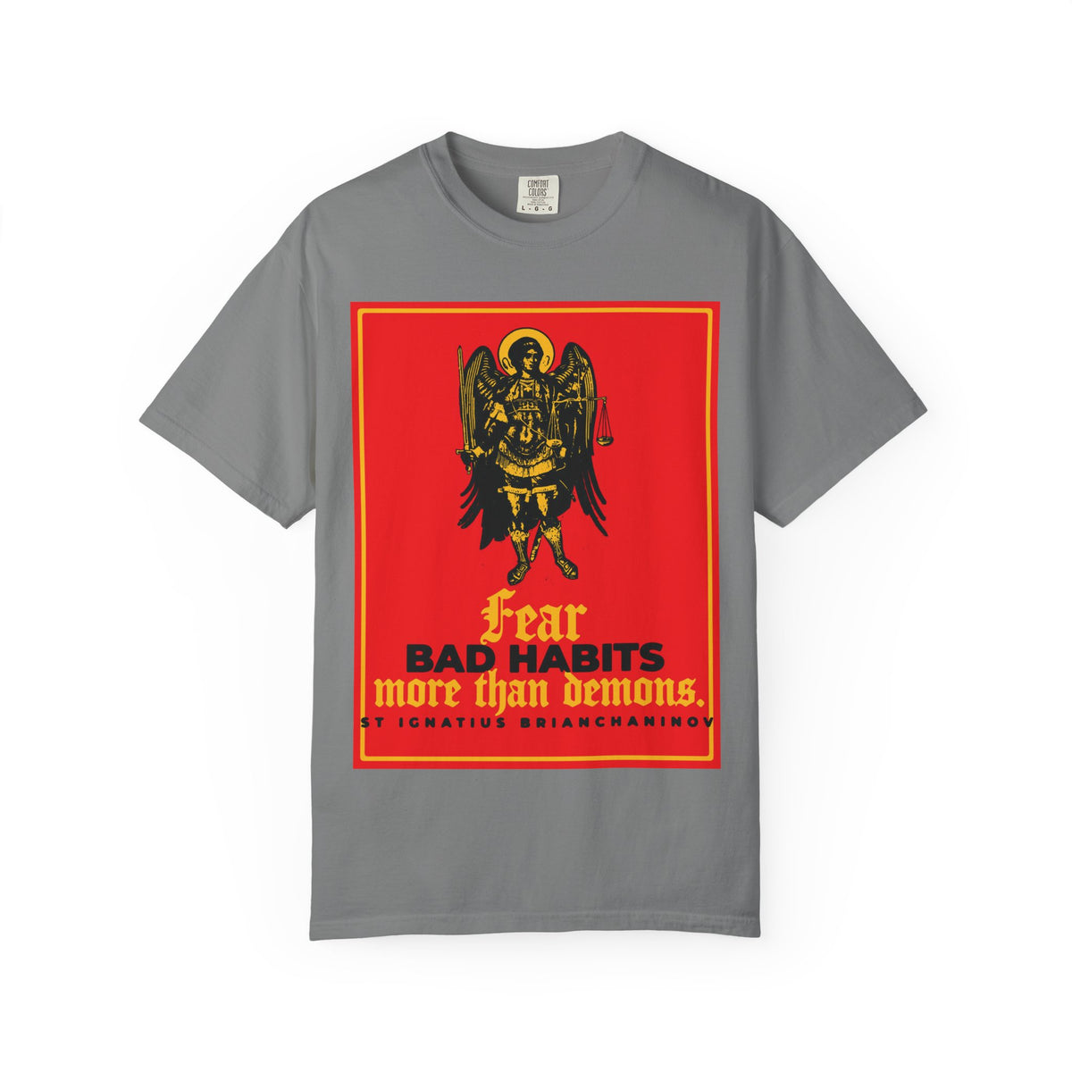 Grey heavyweight cotton unisex tee featuring an Archangel Michael icono-graphic and the quote “Fear BAD HABITS more than demons”—inspired by St Ignatius Brianchaninov—a bold Orthodox statement on moral freedom in the spiritual struggle within.
