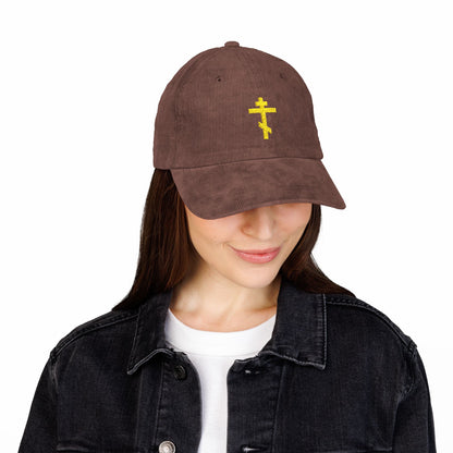 Woman in a black denim jacket and white shirt wears the Simple Yellow Orthodox TriBar Cross Embroidered Cotton Corduroy Cap—a symbol of faith, known as the Weapon of Unseen Warfare that makes demons tremble.