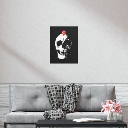 The "You Will Be Here Maps Marker on Skull" poster, featuring a Memento Mori Orthodox Christian design, hangs above a gray sofa with a plaid blanket and a vase of pink flowers.