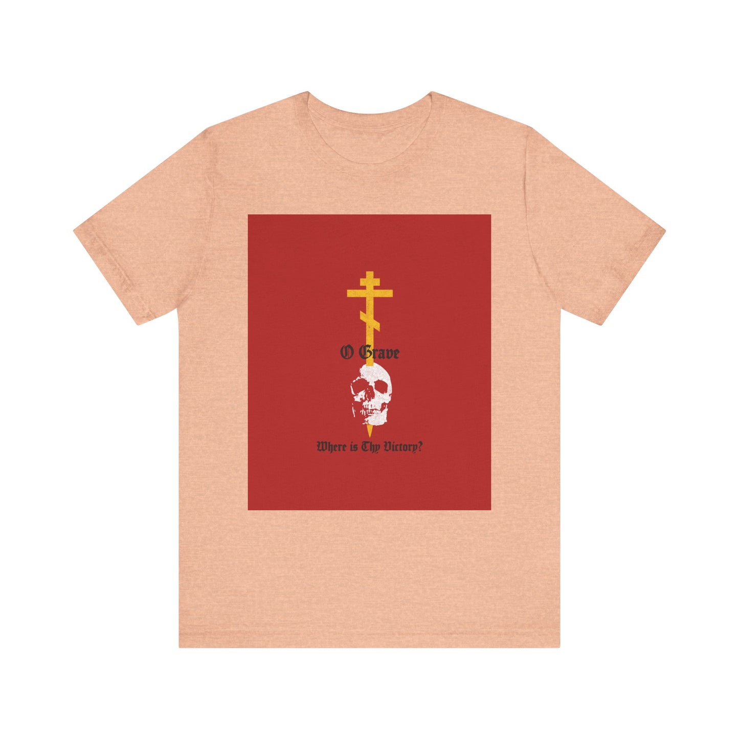 Heather peach t-shirt featuring a red square with a gold Orthodox cross piercing a skull and the text “O Grave, Where Is Thy Victory? 1 Cor 15:55” — a striking Christian reminder of resurrection and salvation.