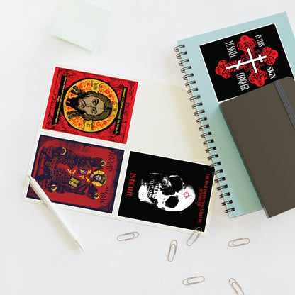 An open notebook with Bestseller Orthodox Sticker Mix No. 3, red and black art, beside another notebook and pen.
