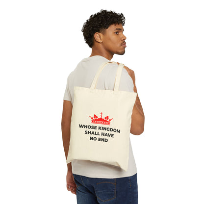 A man with curly hair holds a "Whose Kingdom Shall Have No End" cotton tote bag featuring a red Orthodox cross crown design, inspired by the Nicene Creed and Christian eschatology.