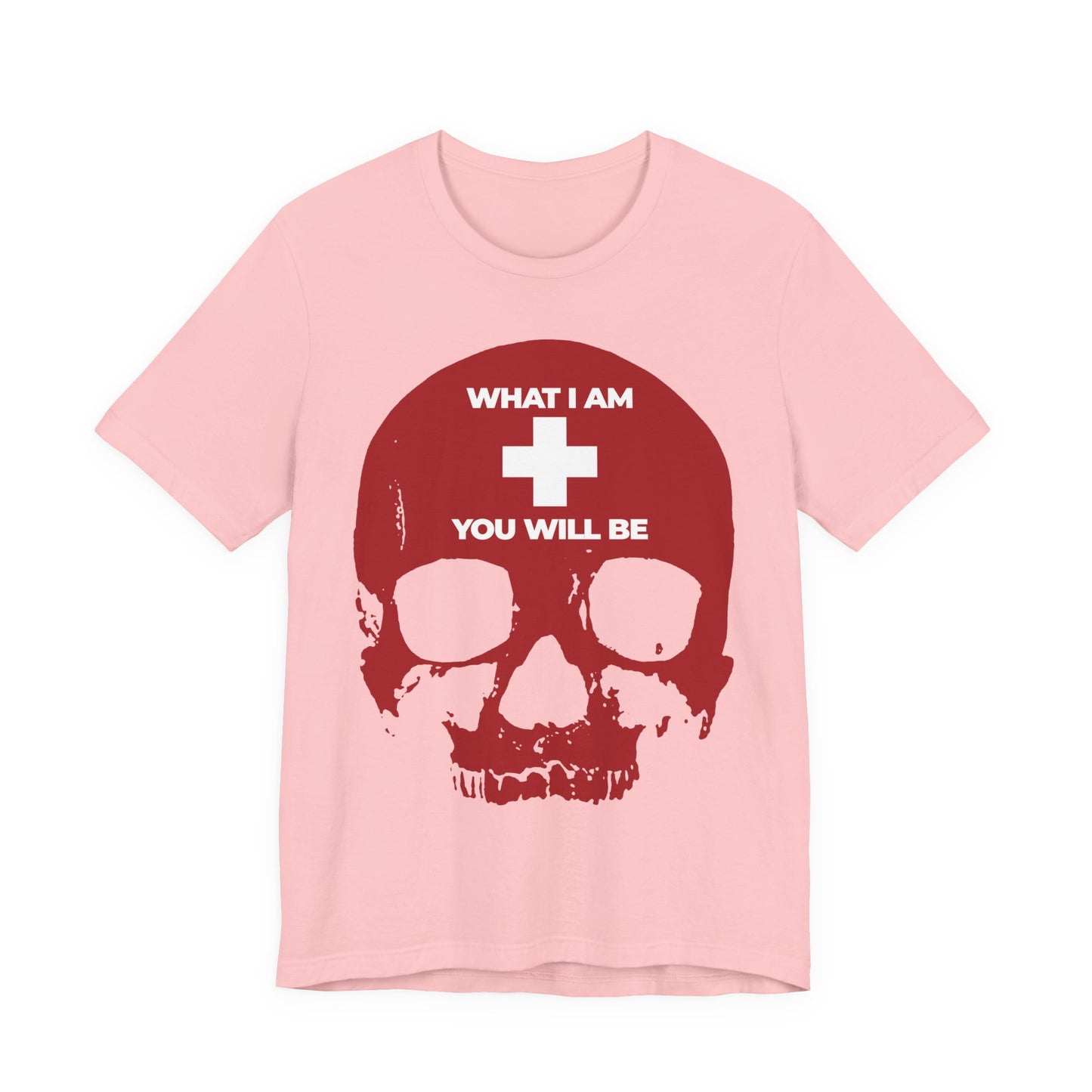 Orthodox Christian Lightweight Cotton Unisex Tee in pink, featuring a red skull with a white cross and the words "WHAT I AM YOU WILL BE." Inspired by Ecclesiastes, this Memento Mori design serves as a reminder of life’s fleeting nature. Product name: What I Am You Will Be White Cross on Red Skull | Remember You Will Die | Memento Mori.