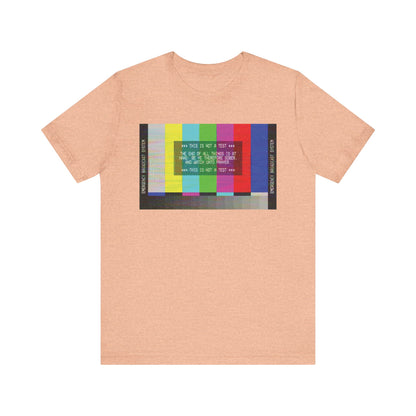 Heather peach unisex tee featuring an Emergency Broadcast System TV graphic and "The End of All Things Is At Hand (1 Peter 4:7)" text on the front—an apocalyptic Christian shirt designed to inspire reflection in every detail.