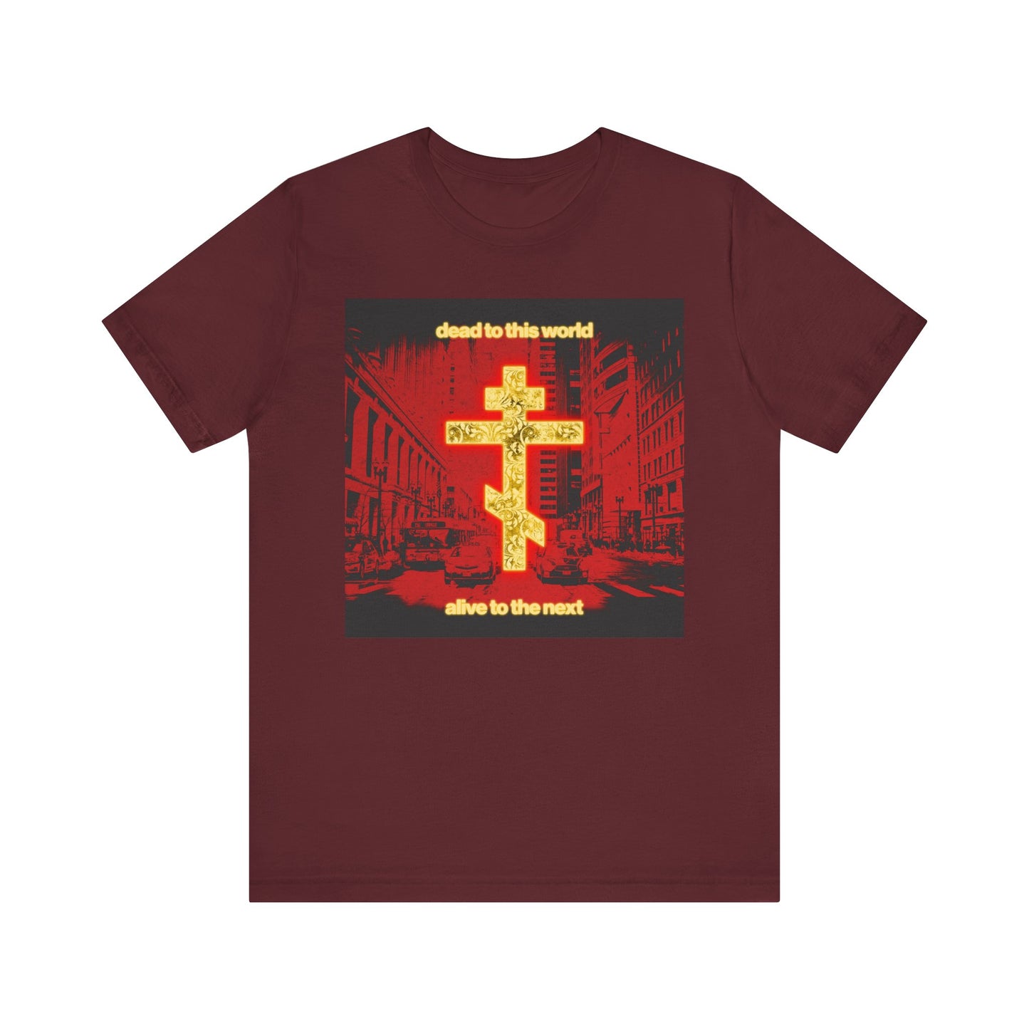 Maroon "Dead to This World Alive to the Next" Orthodox Christian tee features a glowing gold cross and red cityscape—an inspiring nod to St Ignatius Brianchaninov's reflections on death and eternity. Lightweight cotton, unisex fit.