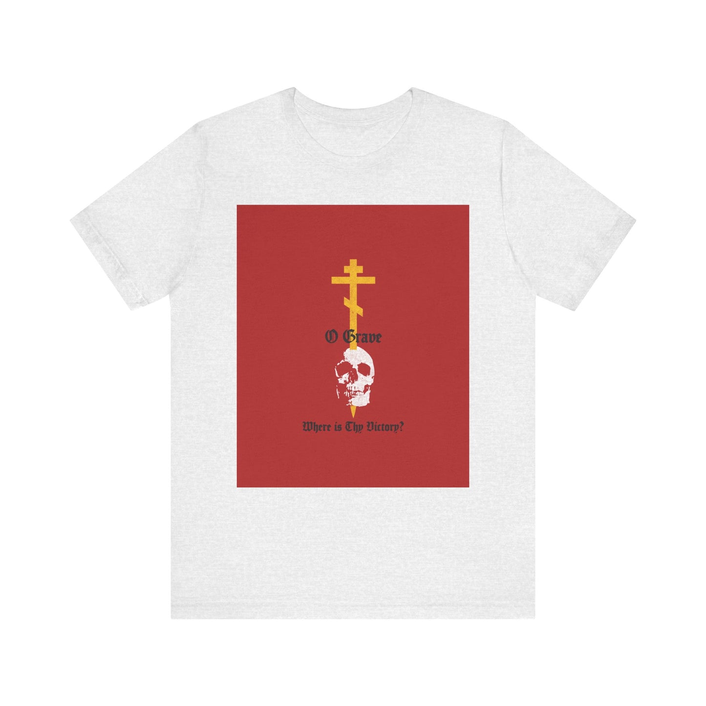 Ash-colored lightweight cotton unisex tee featuring a gold Orthodox cross piercing a white skull, red square accents, and the text: O Grave, Where Is Thy Victory? 1 Cor 15:55—symbolizing resurrection and the promise of immortality.