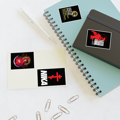 Two spiral notebooks, a pen, paper clips, and Bestseller Orthodox Sticker Mix No. 5 on a white surface.