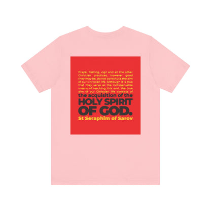 The "True Aim of Christian Life is Acquisition of the Holy Spirit" tee features a St. Seraphim of Sarov quote in red and yellow text on the back. This lightweight unisex cotton shirt highlights a central Orthodox Christian teaching.