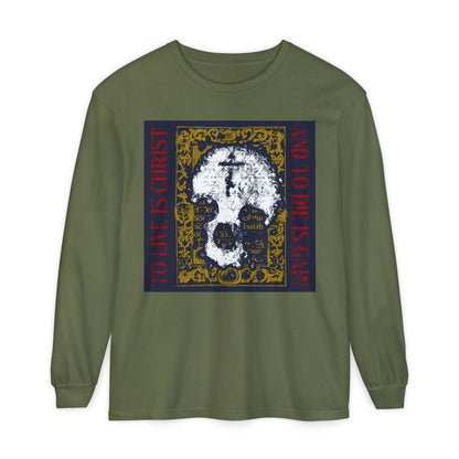 Express your faith with this hemp-colored Orthodox Christian long sleeve shirt featuring a skull with cross on gold manuscript texture and the message: “To Live is Christ, to Die is Gain” (Philippians 1:21).