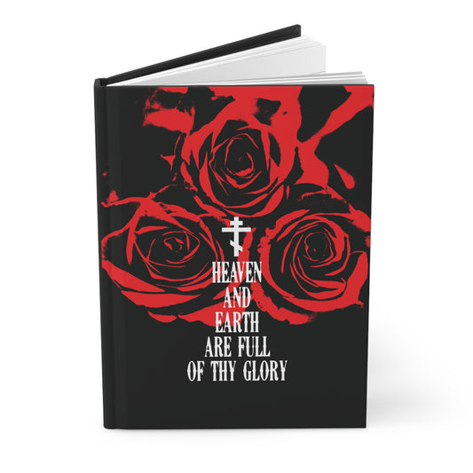 The Remembrance of Death hardcover journal "Heaven and Earth Are Full of Thy Glory" features three red roses, a white Orthodox cross, and bold Western typography on a black cover, inspired by the Orthodox liturgical hymn.