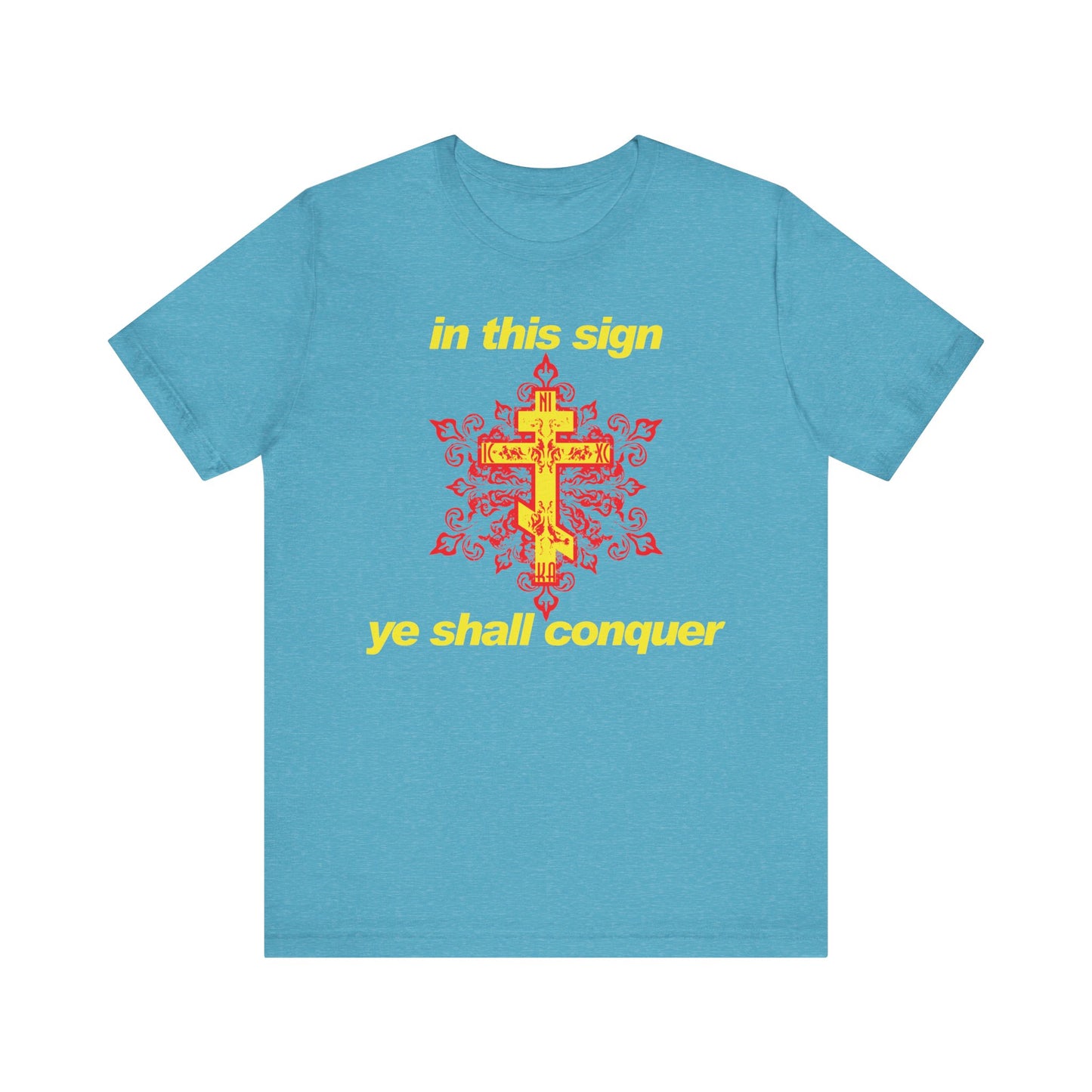 Heather aqua t-shirt featuring a bold red and yellow cross with modern typography stating "In This Sign Ye Shall Conquer," inspired by Orthodox Christian tradition and the wisdom of St Theophan the Recluse.