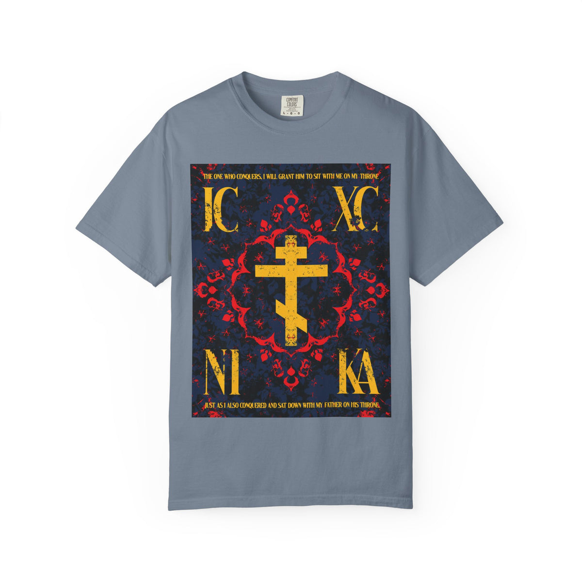 Blue Jean heavyweight cotton unisex t-shirt featuring the IC XC NIKA Orthodox Cross in a medieval floral design, with Greek letters and the phrase “The One Who Conquers” (Revelation 3:21), highlighting God’s grace as essential to salvation.