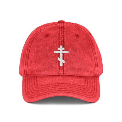 Red "Simple White Orthodox TriBar Cross" cap, featuring a minimalist white cross embroidered on the front with "Crucify My Ego to the Precious and Life Giving Cross" design. Distressed, Christian, and symbolic of faith.
