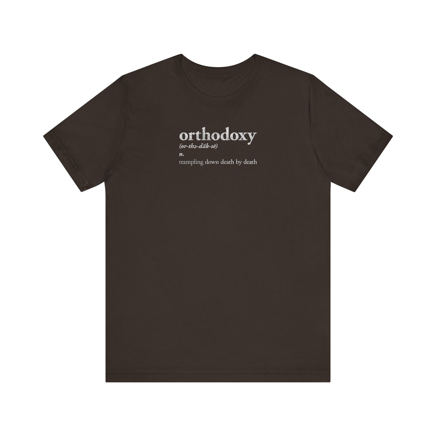 Brown t-shirt featuring the phrase "Orthodoxy Definition: Trampling Down Death By Death | Christ is King | Memento Mori | Pascha" in white text on the front, inspired by Resurrection Great Vespers hymns and phrases such as "Lord I Have Cried" from Tone 2. Lightweight cotton unisex fit.