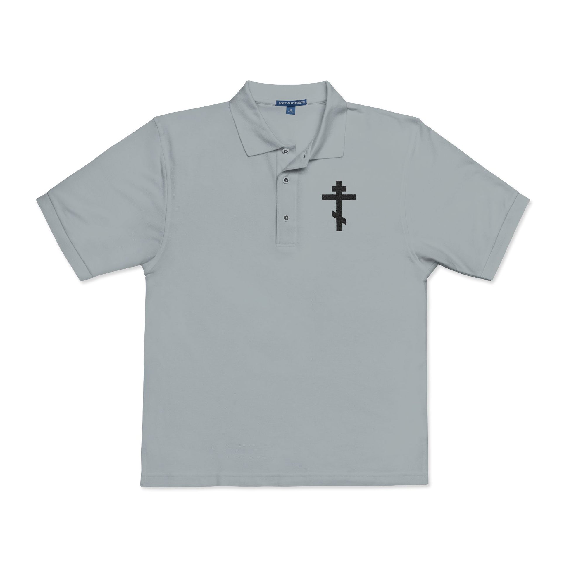 Cool grey polo shirt featuring an embroidered black Orthodox cross with the inscription “May I never boast, except in the cross of our Lord Jesus Christ” (Gal 6:14) on the left chest. Christian-inspired design.