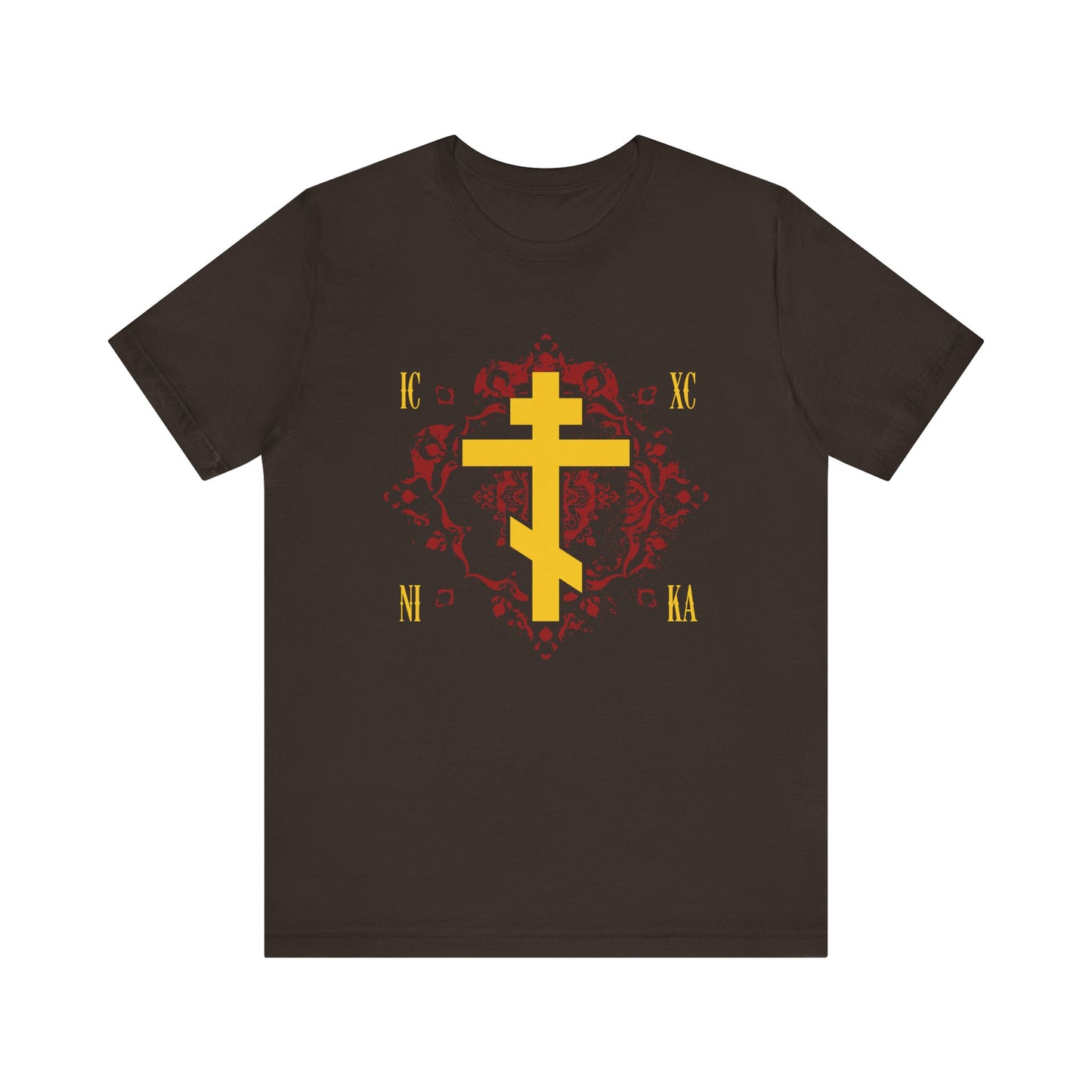 Brown t-shirt featuring the ICXC NIKA yellow Orthodox Cross over an ornate red background design, accented with gold Greek letters at each corner. Inspired by St Kosmas Aitolos, this Christian lightweight cotton unisex tee symbolizes "Jesus Christ Conquers" and showcases meaningful artistry reflecting the grace of sonship.