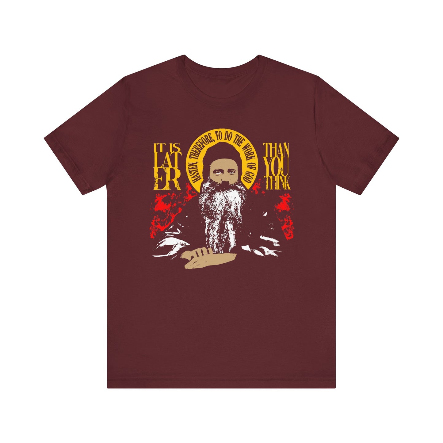 Maroon "It is Later Than You Think, Hasten Therefore to Do the Work of God" T-shirt (Fr Seraphim Rose) in lightweight cotton, featuring a bearded figure with a halo in red and yellow design. Text highlights the message reflecting Orthodox spiritual urgency and depth.