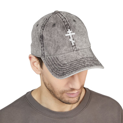 Man wears the Simple White Orthodox TriBar Cross minimalist cap—distressed grey with white embroidery—quietly reflecting on the meaning of the Crucify My Ego to the Precious and Life Giving Cross.