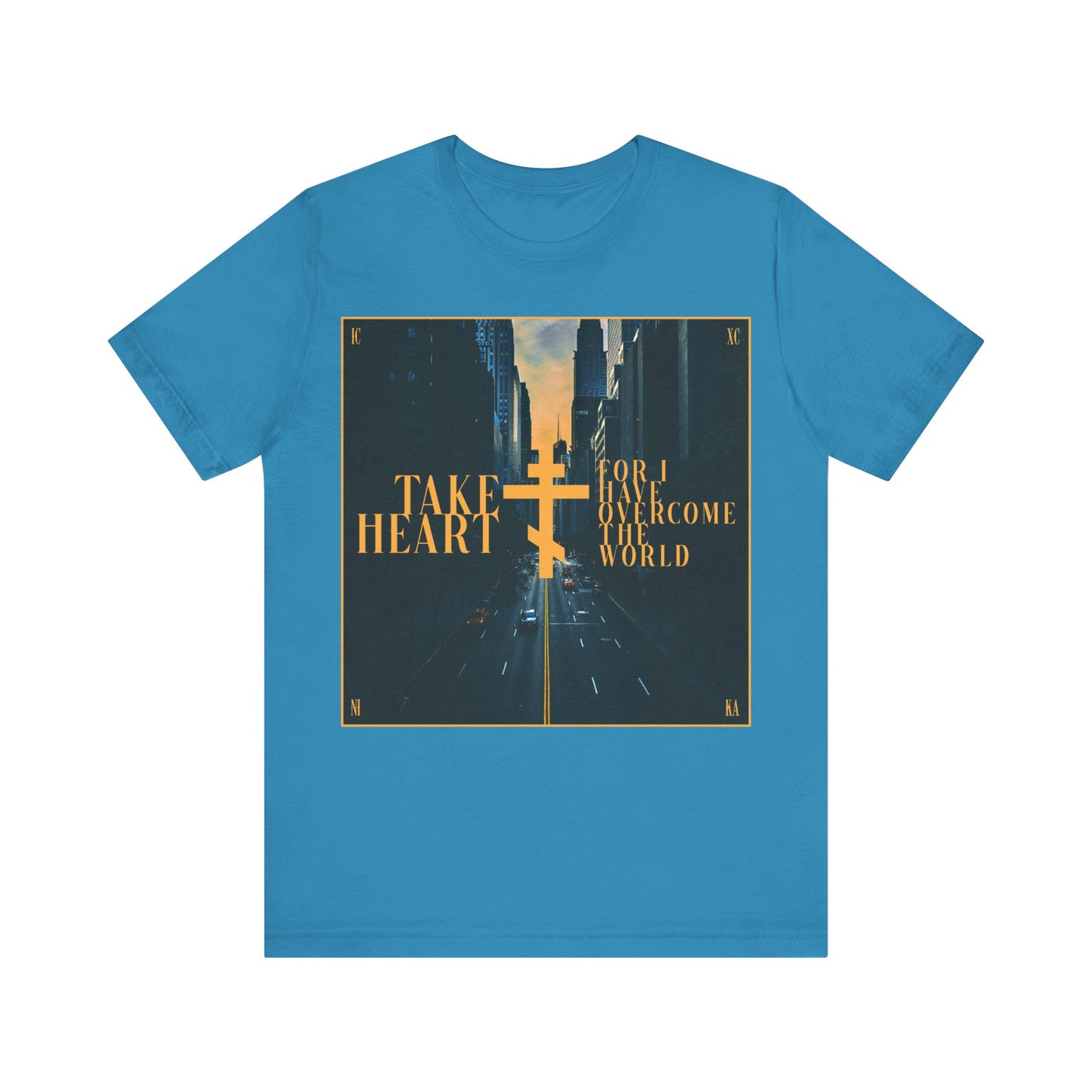 Aqua cotton t-shirt featuring a modern city street scene and “Take Heart, For I Have Overcome the World” (John 16:33). Inspired by Orthodox Christian faith—rejoice in hope and let sorrow turn to joy.