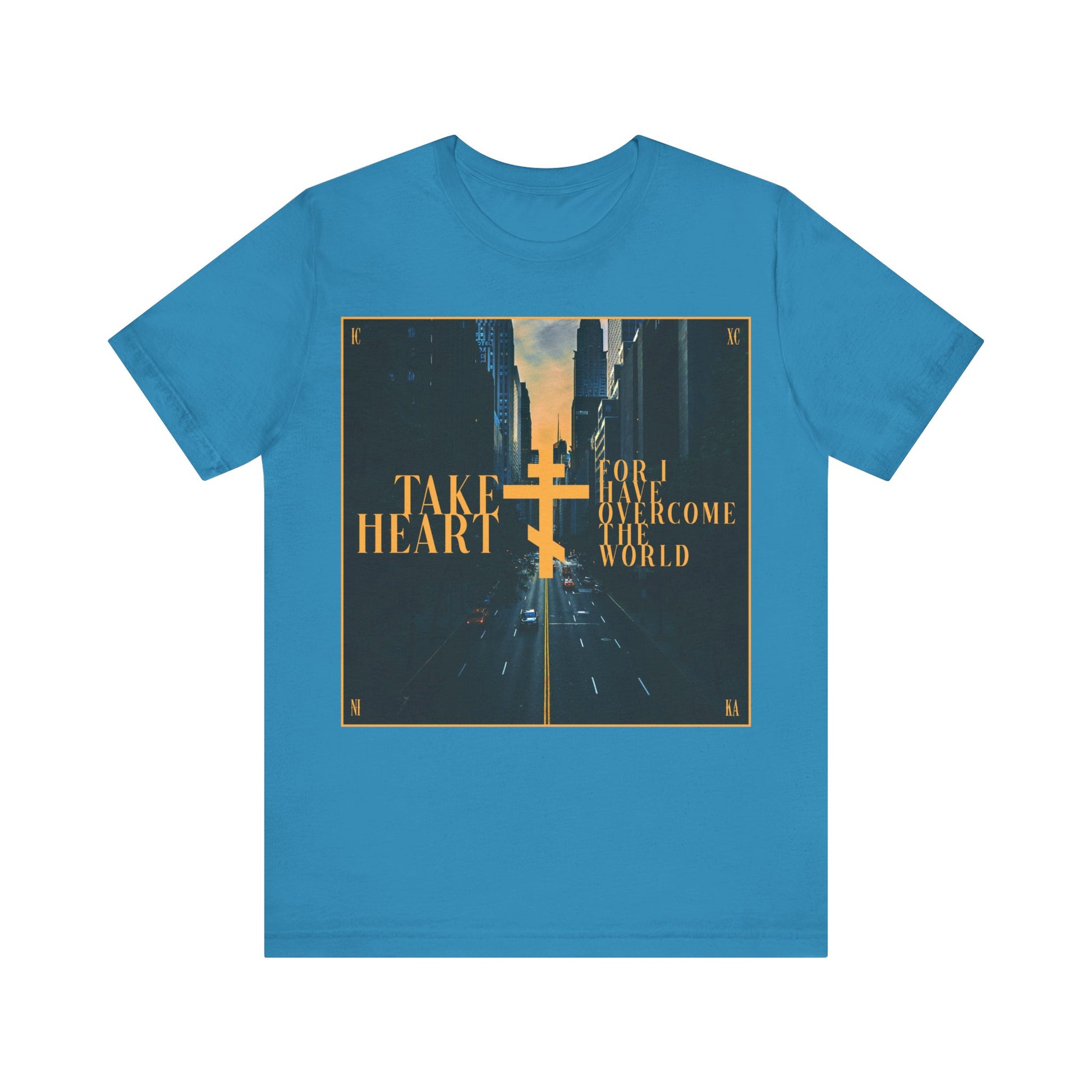Aqua cotton t-shirt featuring a modern city street scene and “Take Heart, For I Have Overcome the World” (John 16:33). Inspired by Orthodox Christian faith—rejoice in hope and let sorrow turn to joy.