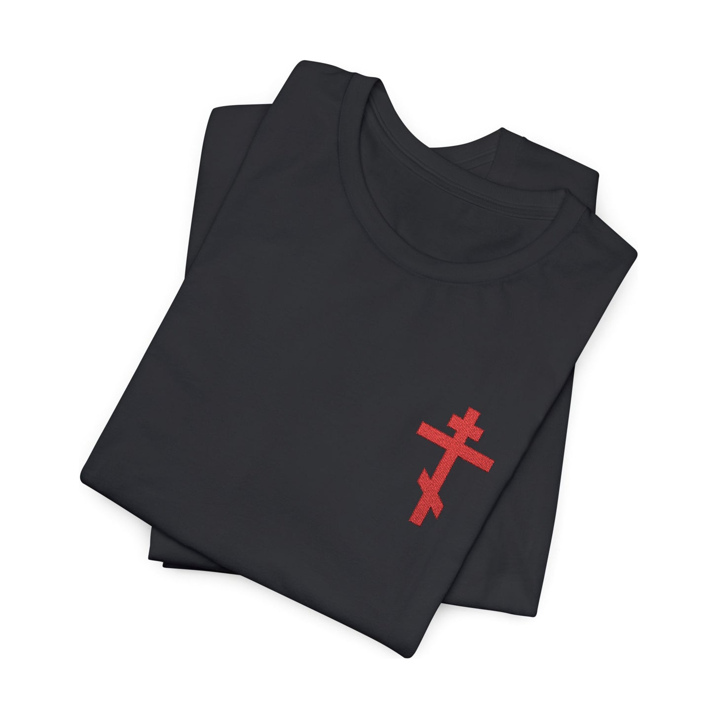 Folded black cotton unisex t-shirt featuring a small red embroidered Orthodox cross, inspired by Galatians 6:14: "May I never boast except in the cross.