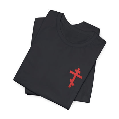 Folded black cotton unisex t-shirt featuring a small red embroidered Orthodox cross, inspired by Galatians 6:14: "May I never boast except in the cross.