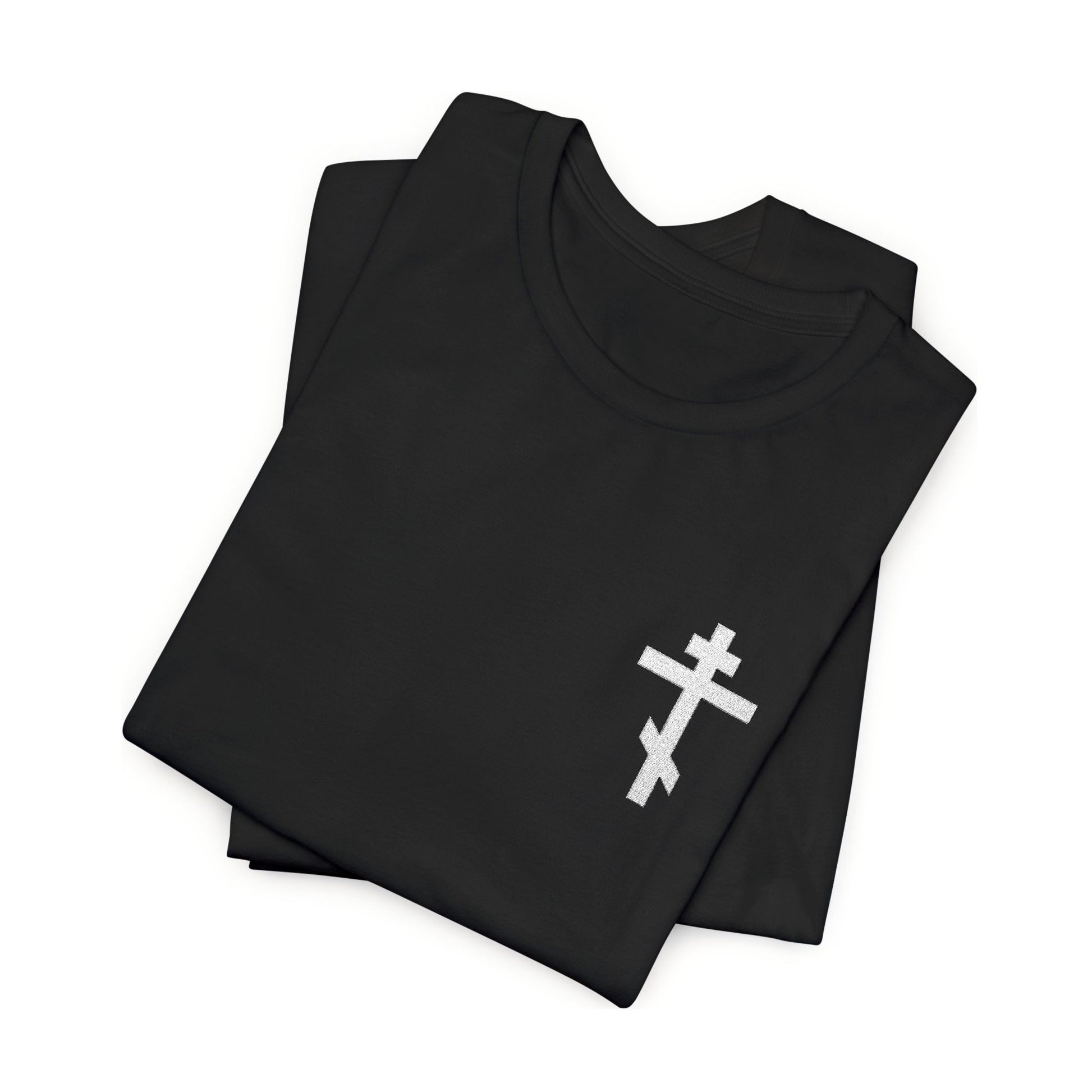 Folded black t-shirt featuring a small embroidered white Orthodox cross, inspired by Gal 6:14 and the message "May I Never Boast Except in the Cross of Our Lord Jesus Christ"—a perfect Christian gift.