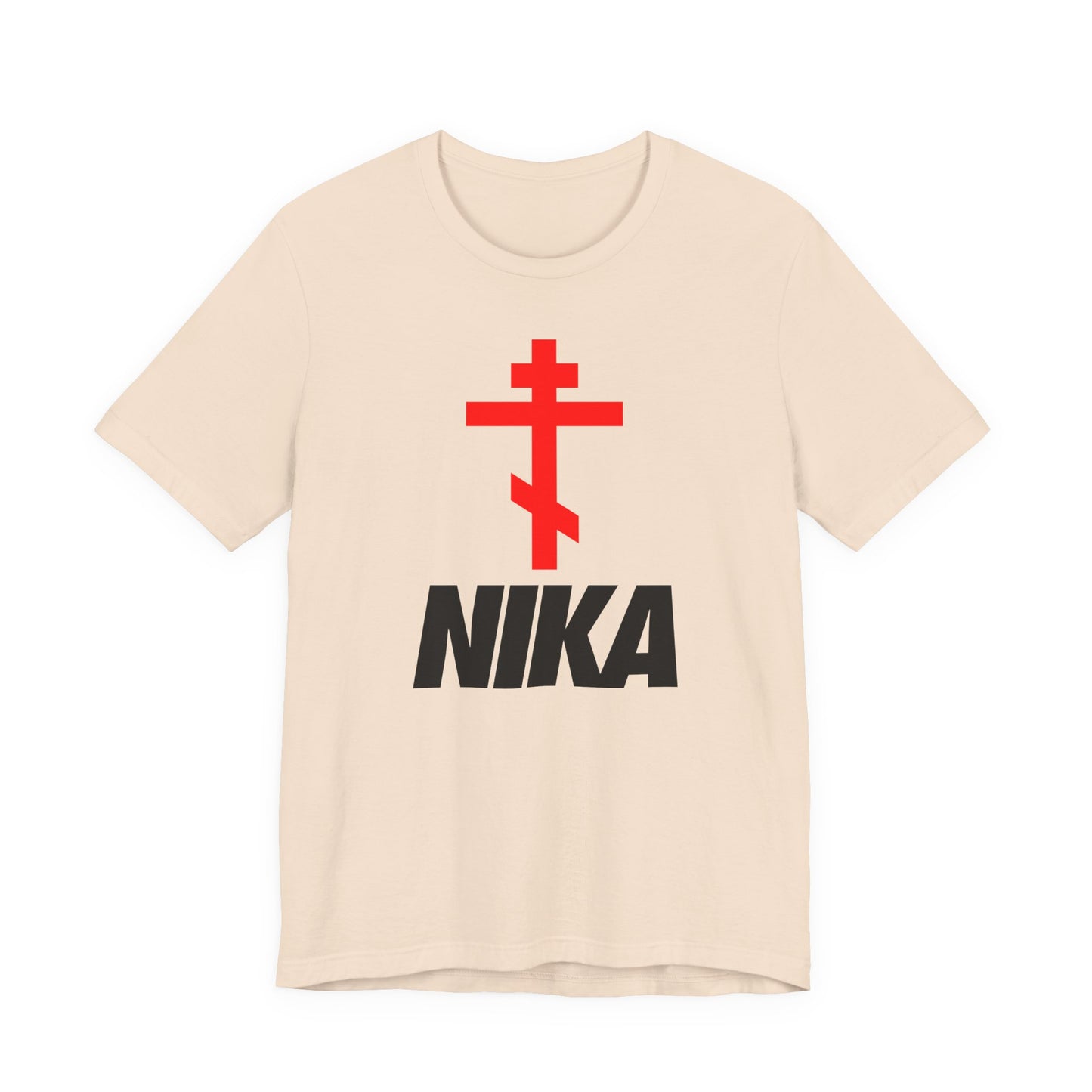 Soft cream t-shirt with a red Eastern Orthodox cross above bold black “NIKA” text, inspired by Christian iconography and minimalist athletic ascetic fashion. Features a NIKE logo mashup and “Jesus Christ Conquers” theme.