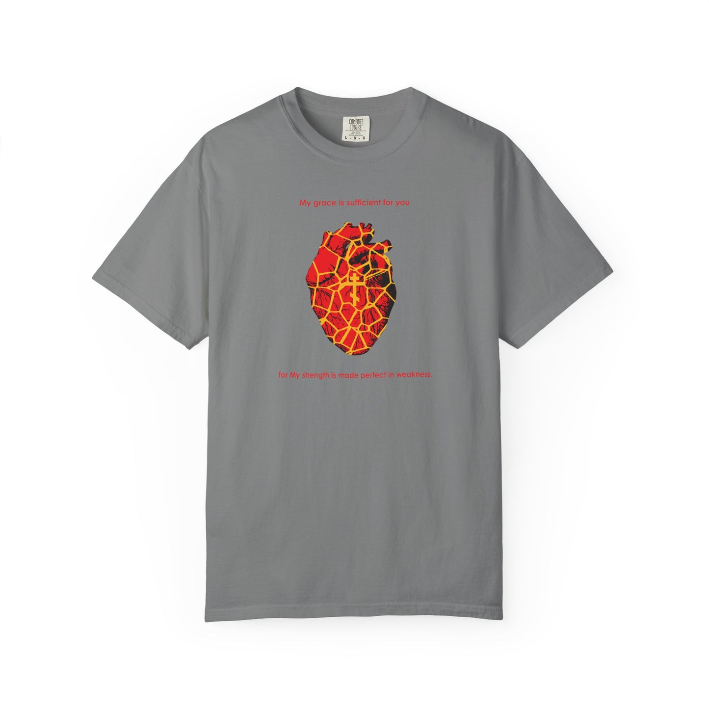 Grey heavyweight cotton unisex tee featuring a kintsugi-style golden broken heart, an Orthodox cross, and the text: “My strength is made perfect in weakness” (2 Cor 12:9)—a moving reminder that even in our brokenness, grace brings restoration.