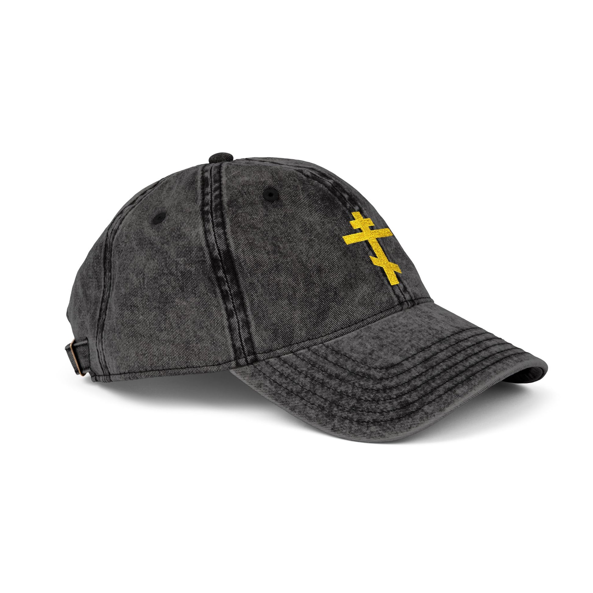 Minimalist faded black cap with a yellow Orthodox TriBar Cross embroidered on the front. "Crucify My Ego to the Precious and Life Giving Cross." Simple, distressed Christian hat.