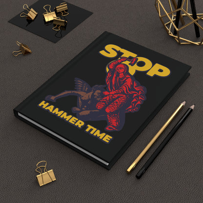 The "St Marina of Antioch Beating the Devil with a Hammer | Stop, Hammer Time" journal features red, blue, and yellow art inspired by Orthodox saints and Christian martyr tales—a modern meme notebook.