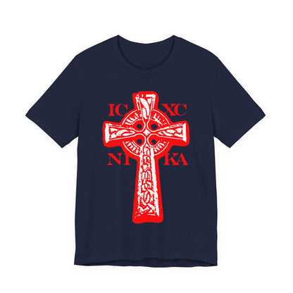 Navy t-shirt featuring a black and white Celtic knotwork Cross on a red background with Greek letters IC XC NIKA, symbolizing “Jesus Christ Conquers.” Traditional Orthodox Christian design.