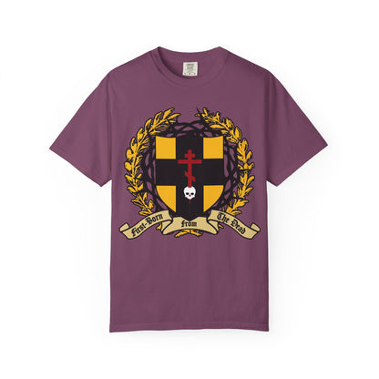 Berry “First-Born from the Dead (Col 1:18)” heavyweight cotton unisex t-shirt featuring a heraldic shield with an Orthodox cross piercing a skull, surrounded by a gold laurel and crowned with thorns—symbolizing redemption through His blood, inspired by the Exodus story of Egypt’s firstborn and the biblical verse.