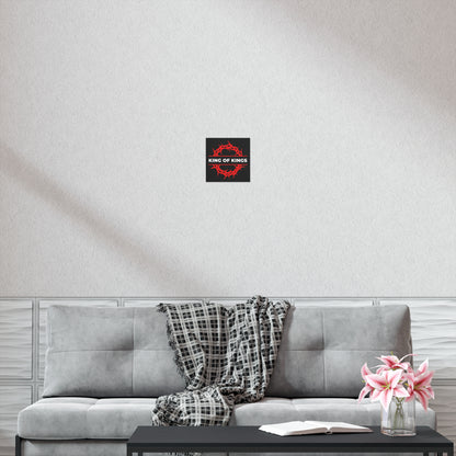 A gray sofa with a plaid throw, pink flowers, and a "King of Kings Crown of Thorns | The King of Glory | Christ is King | Revelation 19:16" Christian art poster above it, inspired by Revelation 19:11-16.