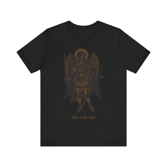 Black cotton t-shirt featuring a bronze iconographic image of Archangel Michael with sword and scales of justice, plus "Who Is Like God?" text. Orthodox Christian design.