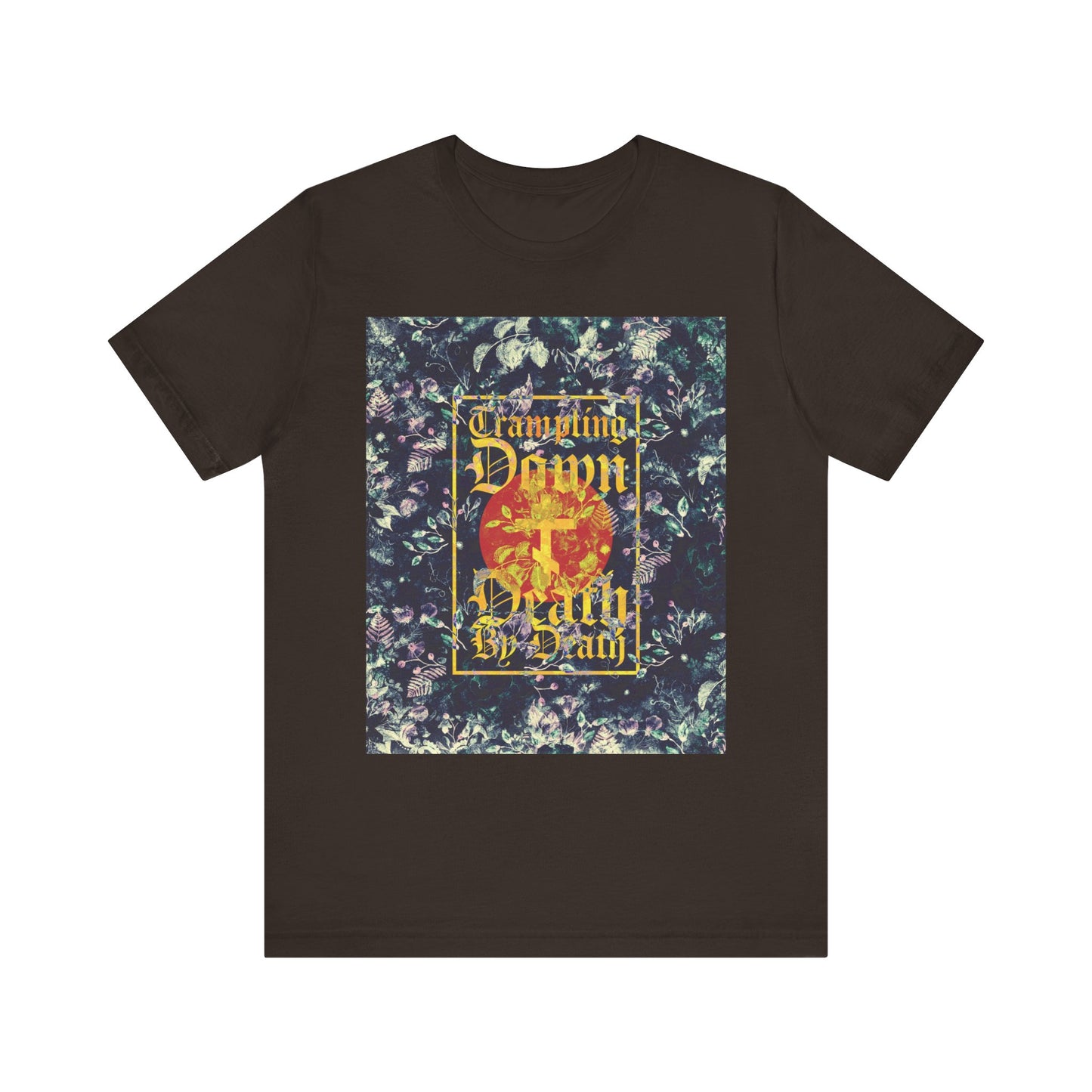 Brown t-shirt featuring a Paschal floral design, yellow gothic script reading “Trampling Down Death By Death,” and a three-bar cross—an Orthodox unisex tee inspired by the triumphant spirit of Jesus Conqueror and the Akathist to Jesus.