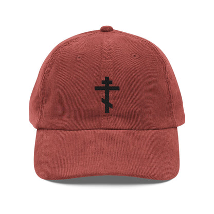 A red cotton corduroy cap featuring a black Orthodox TriBar Cross embroidery, inspired by St. John of Kronstadt’s faith—a Simple Black Orthodox TriBar Cross cap, the Weapon of Unseen Warfare Which Makes Demons Tremble.