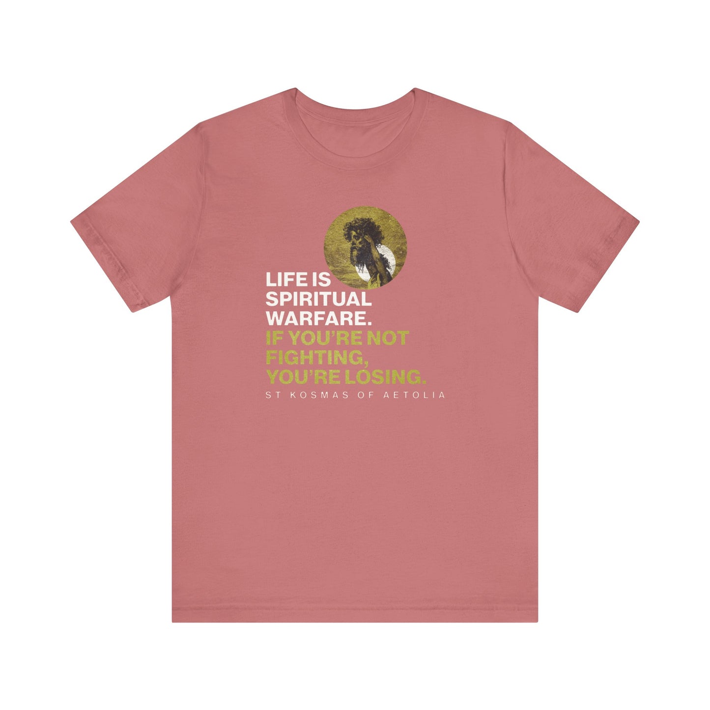 Mauve Orthodox tee features the quote “Life is spiritual warfare. If you’re not fighting, you’re losing,” with St Kosmas of Aetolia and David & Goliath by Gustave Dore—combining faith, perseverance, and unseen warfare.