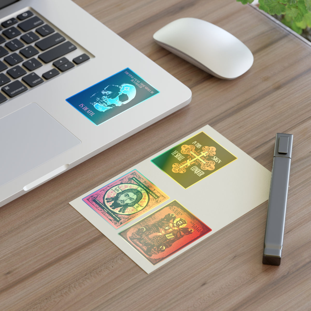 A laptop and mouse on a desk with Bestseller Orthodox Sticker Mix No. 3 and vibrant tarot-themed decor.