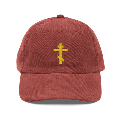 A red cotton corduroy cap with a simple yellow Orthodox TriBar cross embroidered on the front—known as the Weapon of Unseen Warfare which makes demons tremble. Perfect for Orthodox Christian believers.