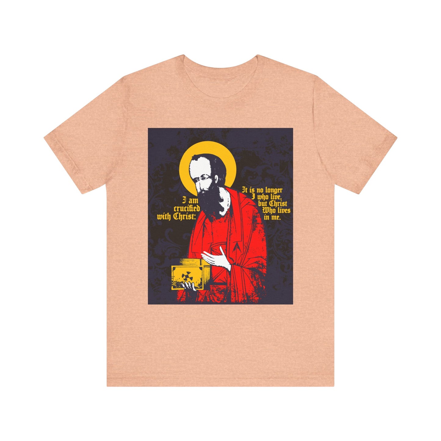 A bearded St. Paul in a red robe with a halo, holding the Gospel and featuring the quote "I am crucified with Christ, living a new life in Christ by faith in the Son of God" (Galatians 2:20), printed on a Heather Peach Orthodox Christian lightweight cotton unisex tee.