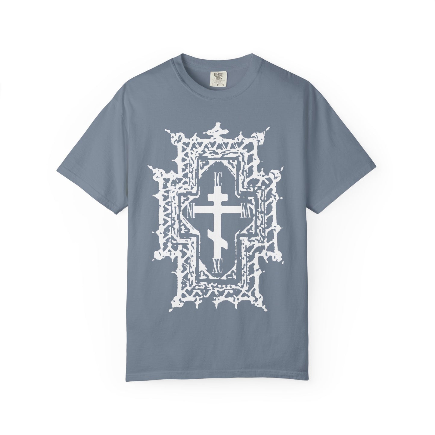 Blue Jean heavyweight cotton unisex tee featuring a large white Gothic cathedral-style Orthodox cross in the center, with ornate abstract detailing inspired by the crown of thorns and Jesus Christ’s suffering, bearing the inscription “ICXC NIKA | Healed By His Wounds.”.