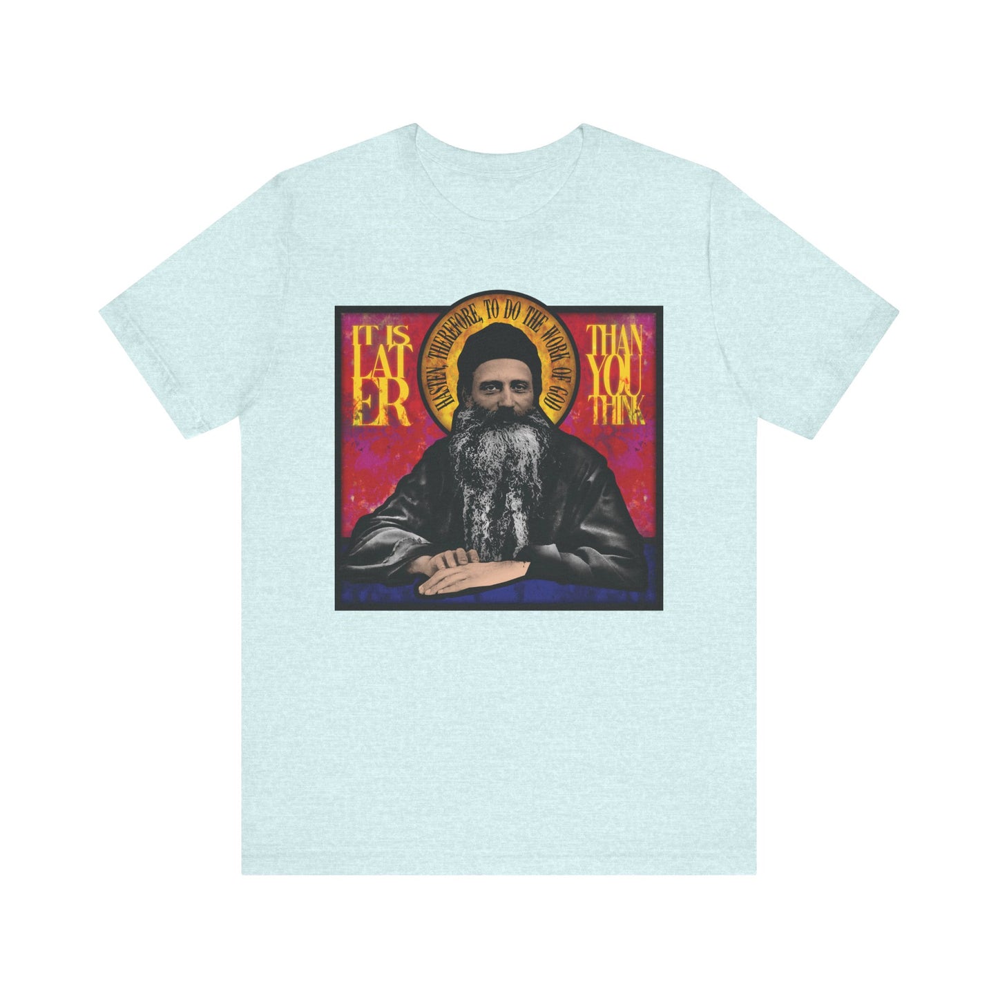 Heather Prism Ice Blue T-shirt featuring Fr. Seraphim Rose in a stained glass design and the phrase "It Is Later Than You Think," inspired by the American Orthodox monastic saint. Lightweight cotton, unisex fit.