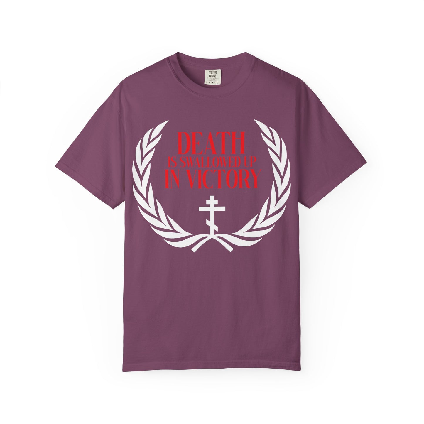 Berry t-shirt featuring a white victory wreath and an Orthodox cross, with bold red text: DEATH IS SWALLOWED UP IN VICTORY (1 Cor 15:54), symbolizing the triumph of immortality over death.