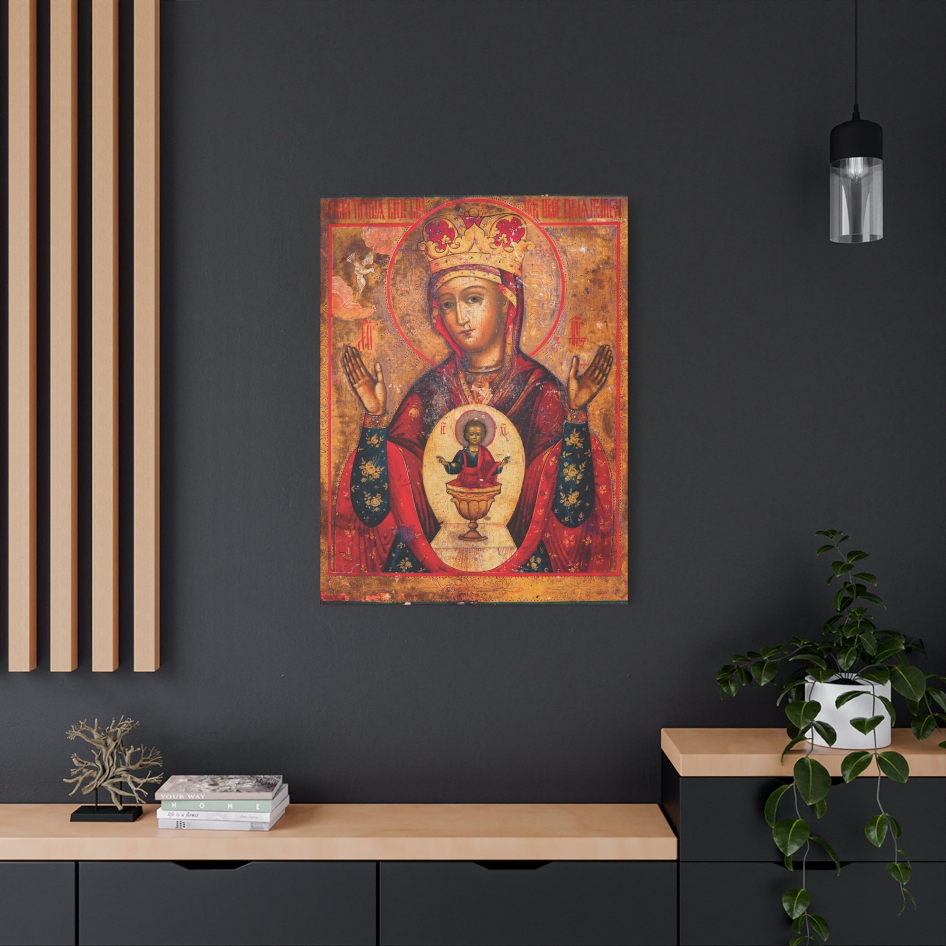 The “Mother of God of Nicaea Russian Orthodox Christian Icon | Panagia | Theotokos Mary | Religious Canvas Sacred Wall Art” is displayed on a dark wall above a modern desk adorned with plants and books.