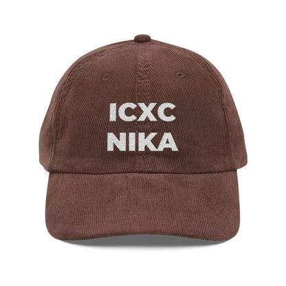Dark brown corduroy cap with white embroidered ICXC NIKA Christogram, meaning "Jesus Christ Conquers," on the front. Orthodox Christian symbol; cap is 100% cotton.