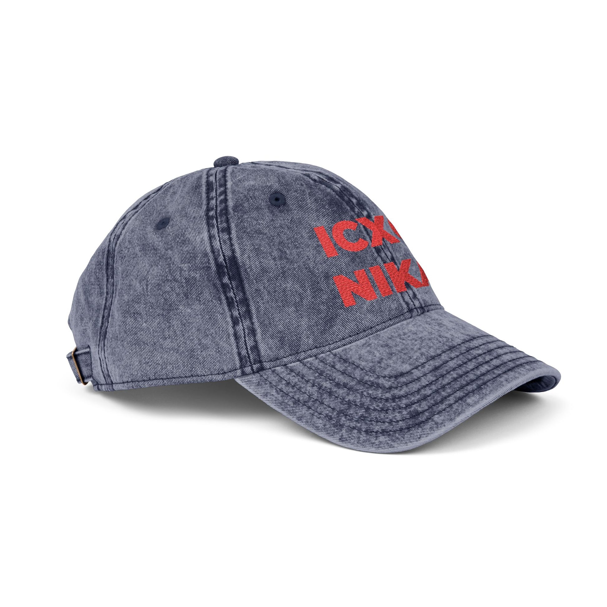 Distressed denim cap featuring red ICXC NIKA text—Orthodox Christogram meaning "Jesus Christ Conquers"—embroidered on the front.